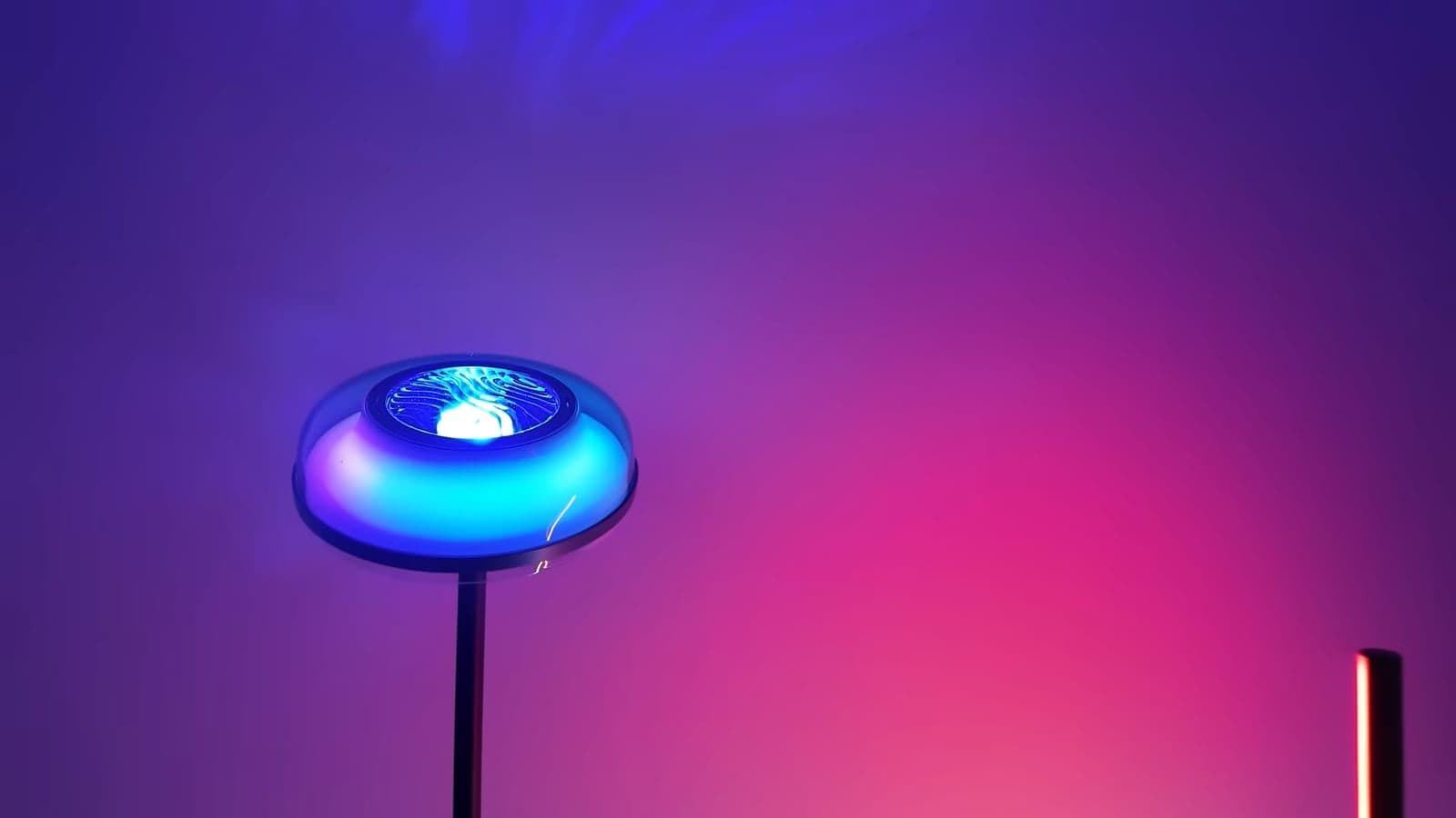 The circular top prism head of the Govee Uplighter glowing bright blue