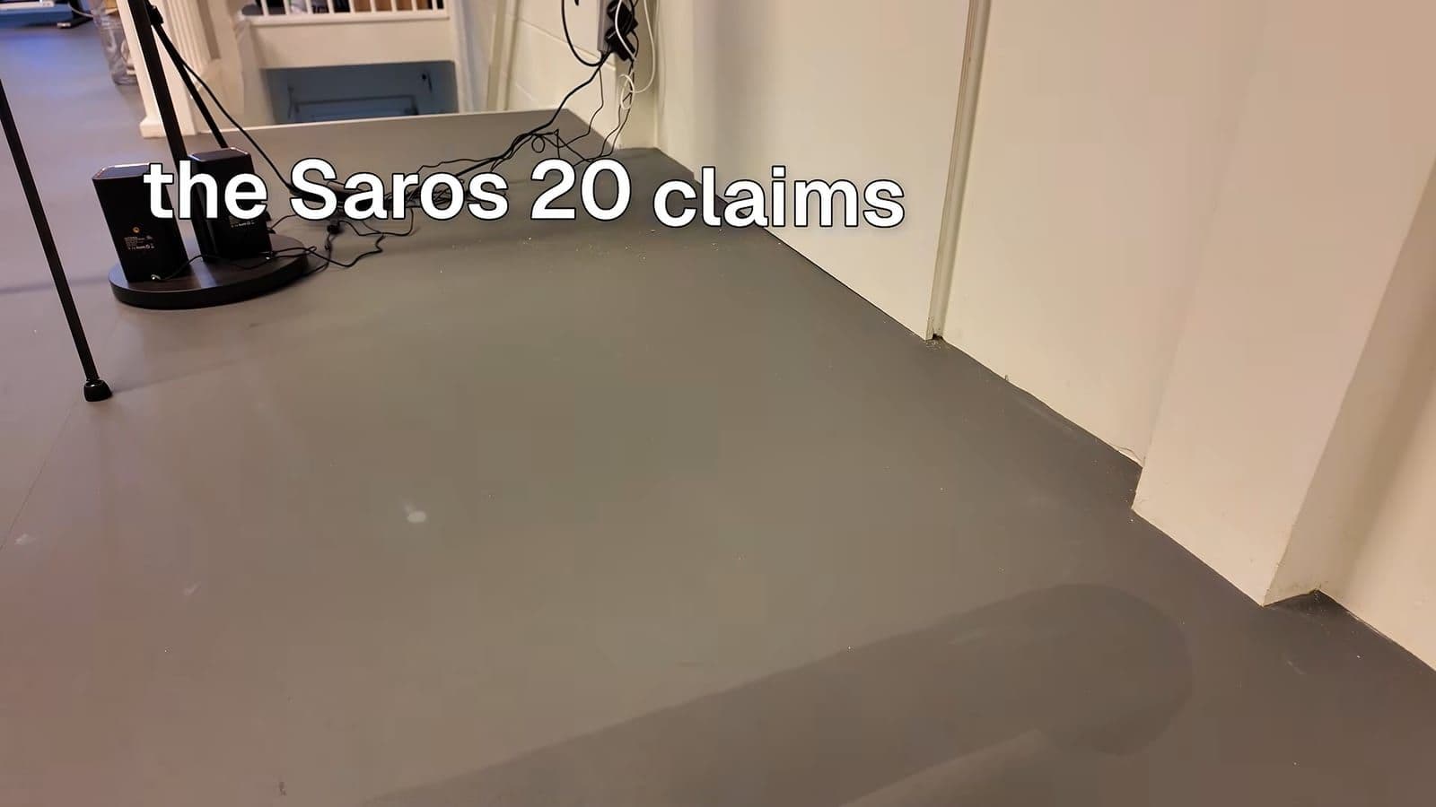 The Saros 20 vacuuming neatly around desk legs and hanging wires