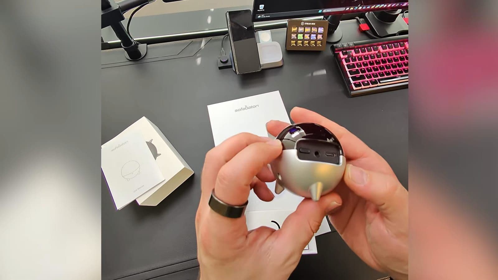 Unboxing the spherical IR hub accessory showing its port openings and feet