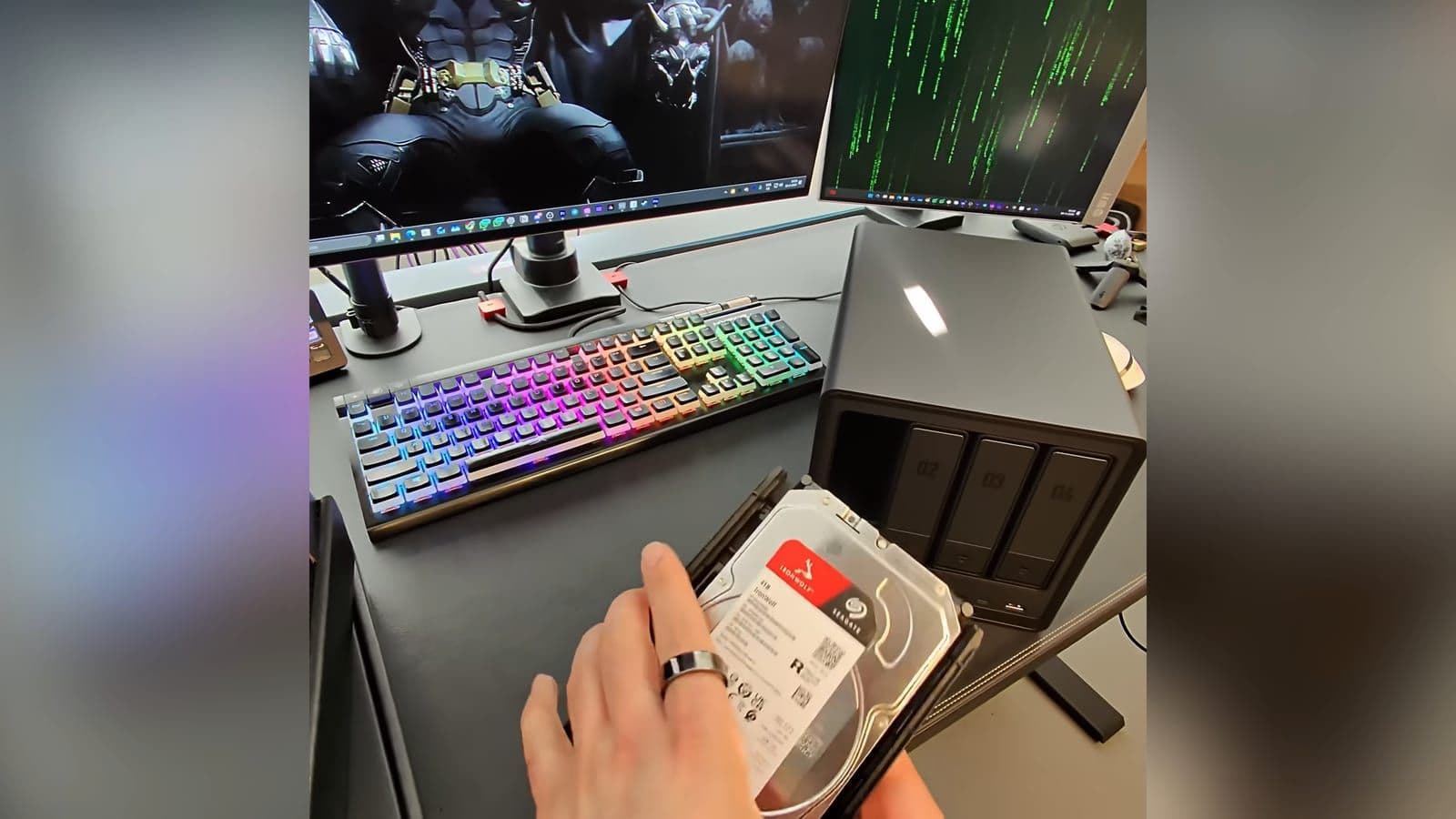 A 3.5 inch Seagate IronWolf hard drive being clipped into the toolless drive caddy of the NAS