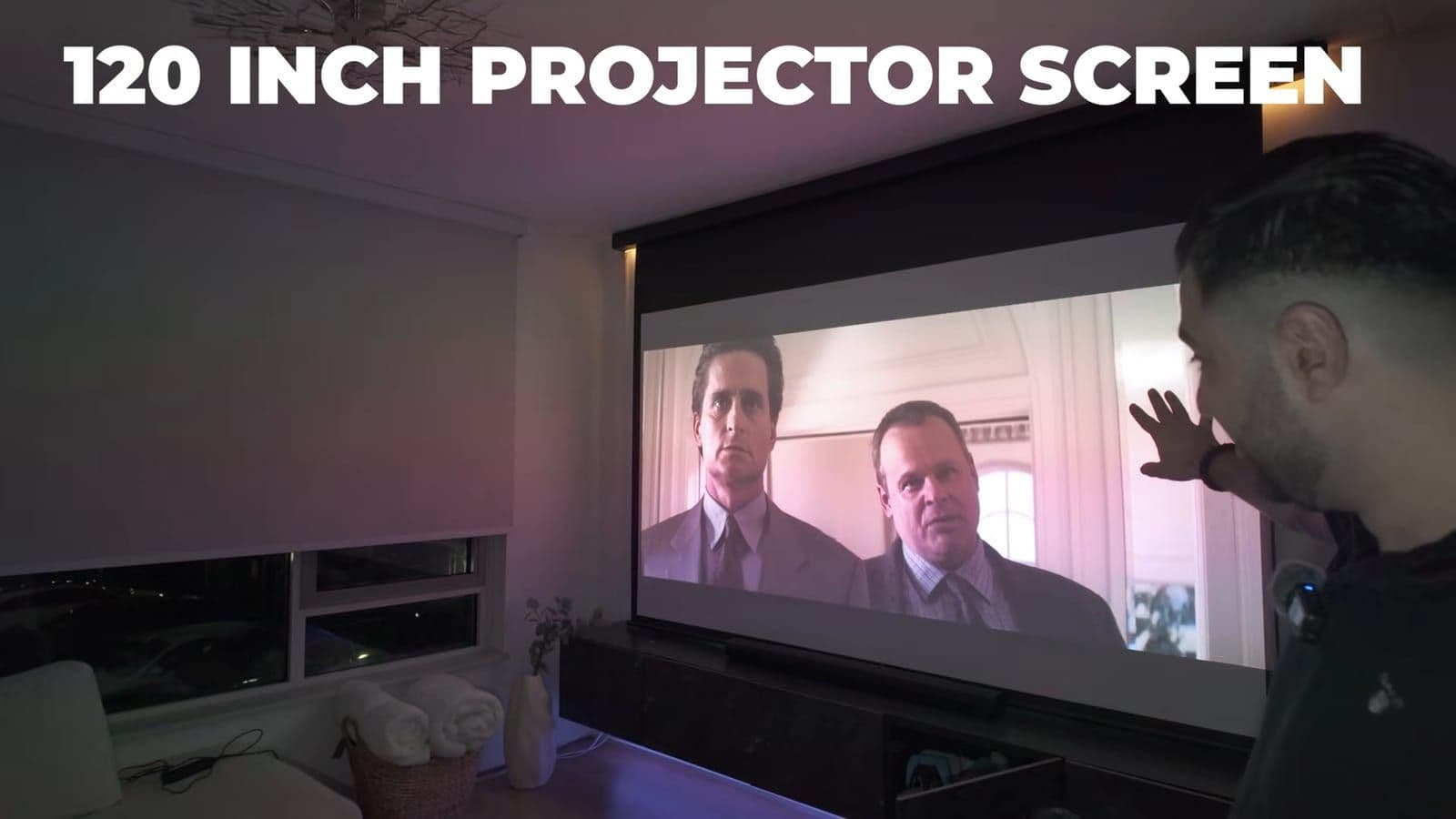 120-inch motorized projector screen displaying movie details for Basic Instinct